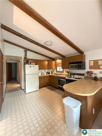 a view of a kitchen with appliances and cabinets