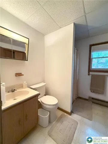 a bathroom with a toilet sink and mirror