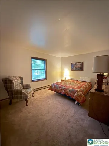 a bedroom with a bed and lamp