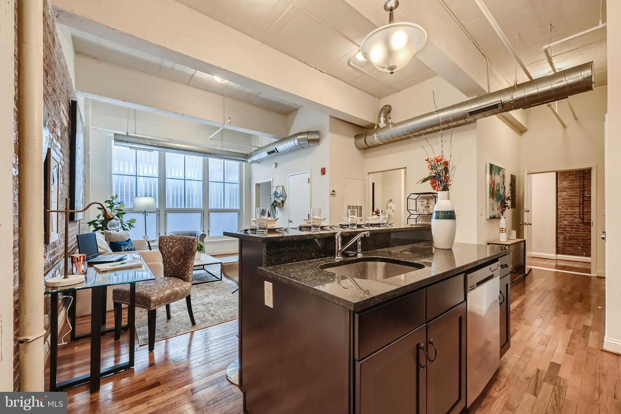311 West Baltimore Street, Unit 503 Baltimore, MD 21201 - Photo 4 of 29 a kitchen with a counter space a sink cabinets and appliances