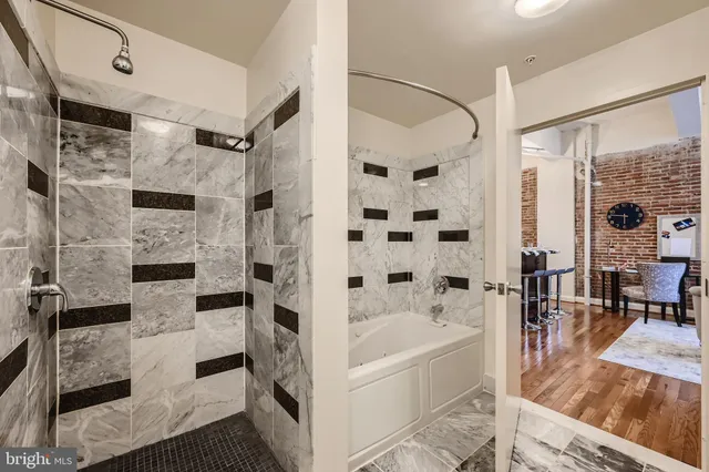 a bathroom with a tub sink and a mirror