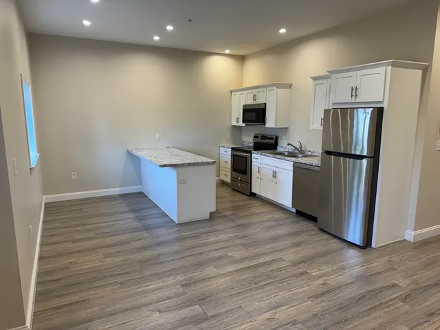 a kitchen with stainless steel appliances a refrigerator stove microwave and sink