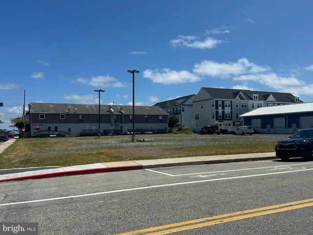 a view of a large building with a big yard and large trees