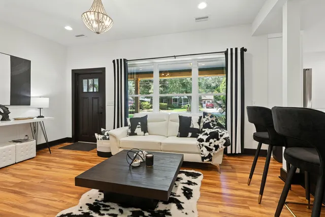 a living room with furniture and wooden floor