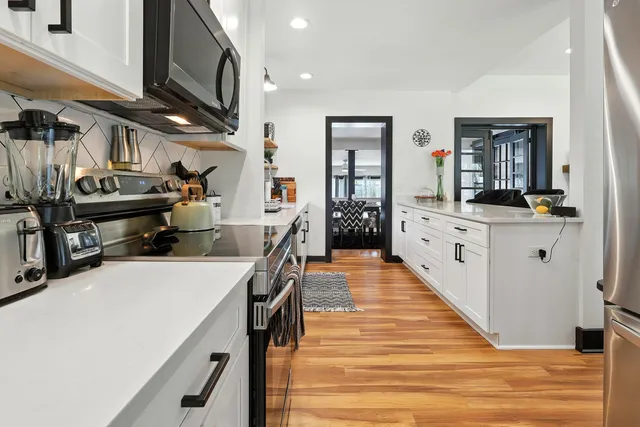 a bathroom with a granite countertop sink a toilet and a shower