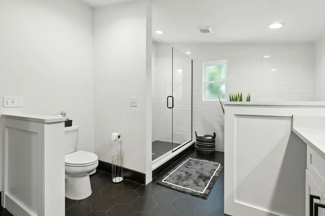 a living room with furniture a rug and a flat screen tv