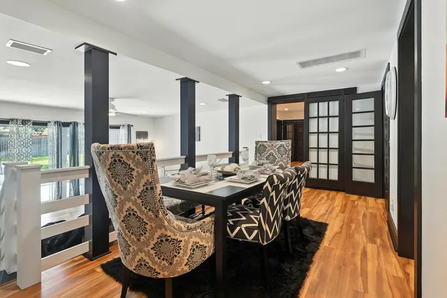a living room with fireplace furniture and a large window