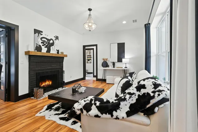 a spacious bedroom with a bed and a flat screen tv