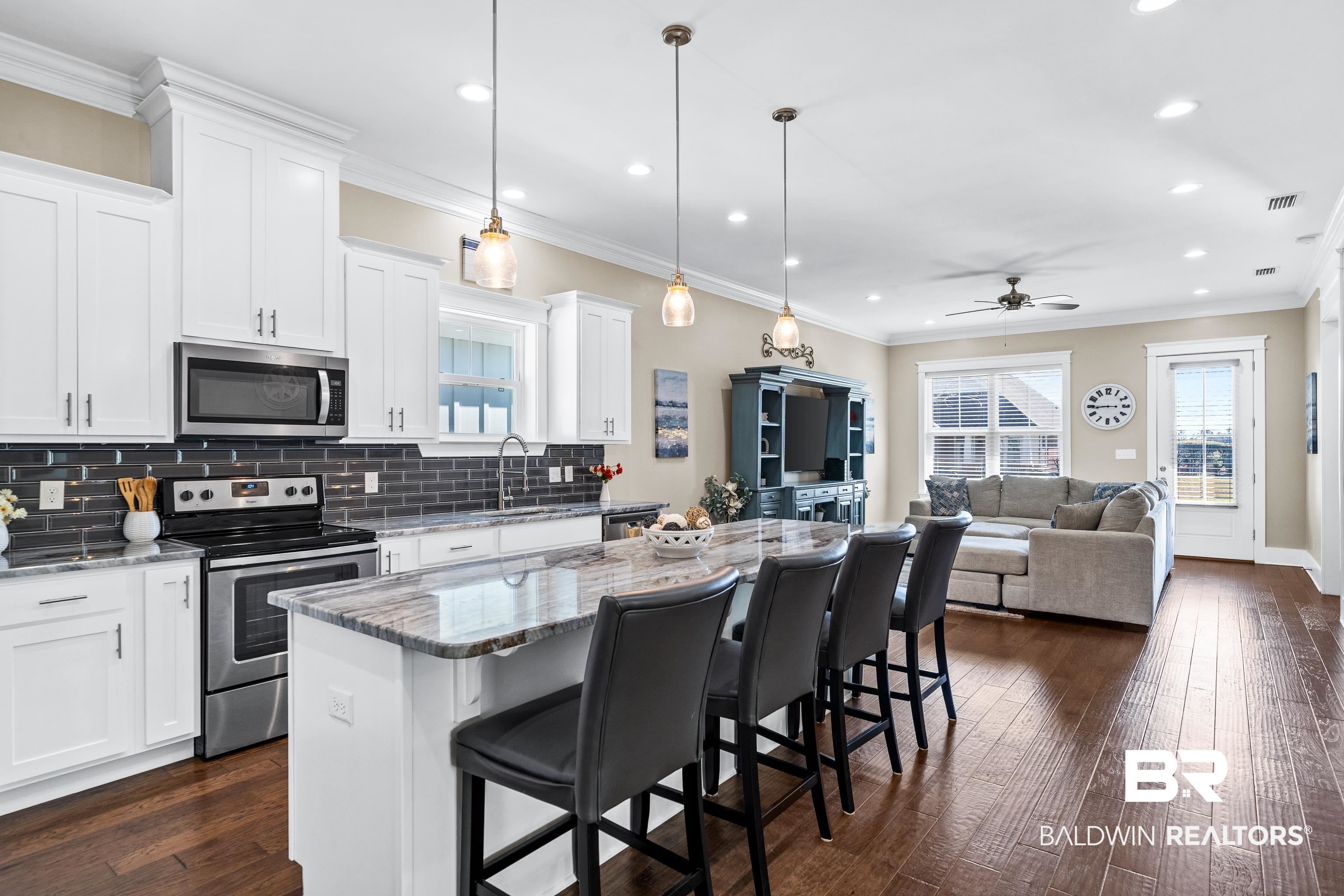 1018 Snapdragon Lane Foley, AL 36535 - Photo 16 of 37 Kitchen with stainless steel appliances, a kitchen island, ceiling fan, pendant lighting, and white cabinetry