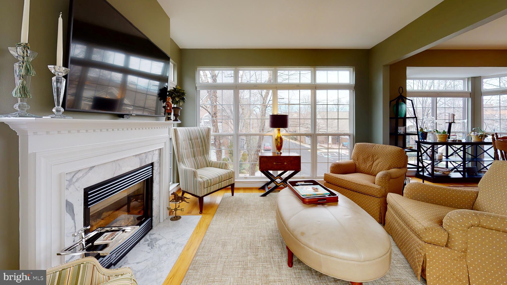1880 Crescent Park Drive Reston, VA 20190 - Photo 20 of 51 a living room with furniture a fireplace and large windows
