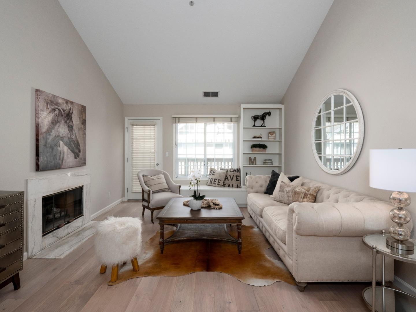 935 Old County Road, Unit 45 Belmont, CA 94002 - Photo 2 of 18 a living room with furniture large window and a fireplace