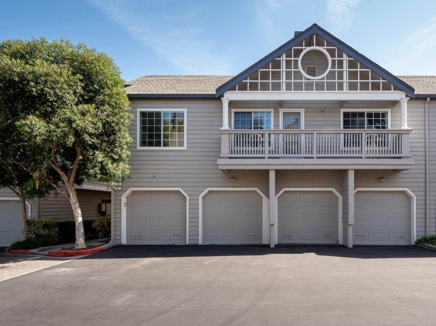 935 Old County Road, Unit 45 Belmont, CA 94002 - Photo 17 of 18 a front view of a house with a yard and garage