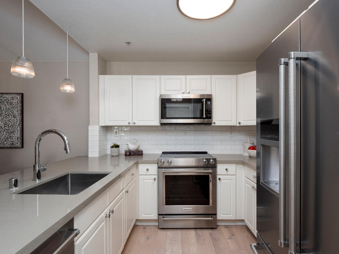 935 Old County Road, Unit 45 Belmont, CA 94002 - Photo 5 of 18 a kitchen with a sink cabinets and stainless steel appliances
