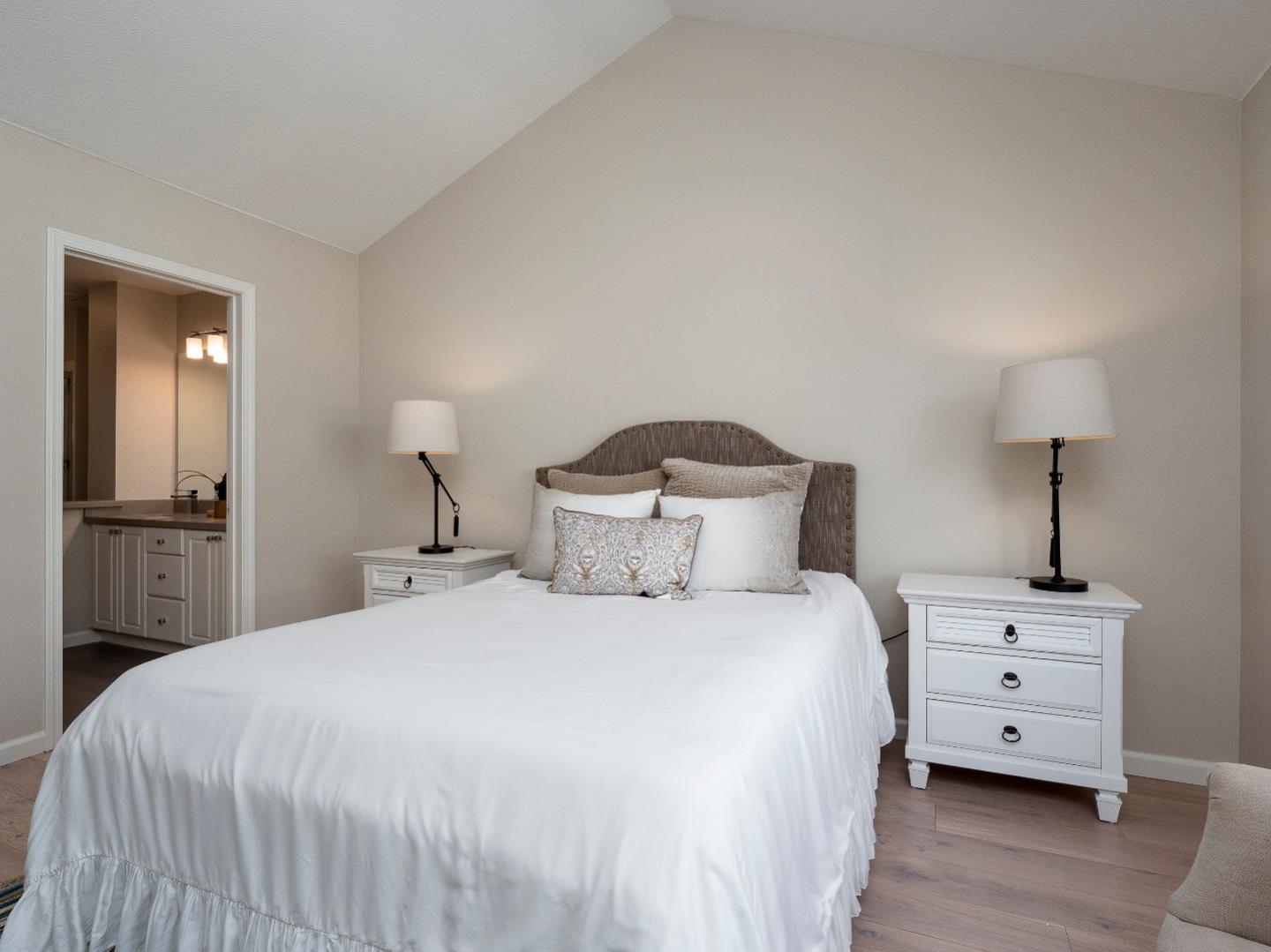 935 Old County Road, Unit 45 Belmont, CA 94002 - Photo 7 of 18 a bedroom with a bed and a night stand