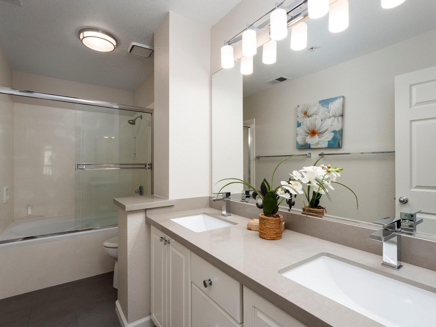 935 Old County Road, Unit 45 Belmont, CA 94002 - Photo 8 of 18 a bathroom with a sink double vanity granite and a mirror