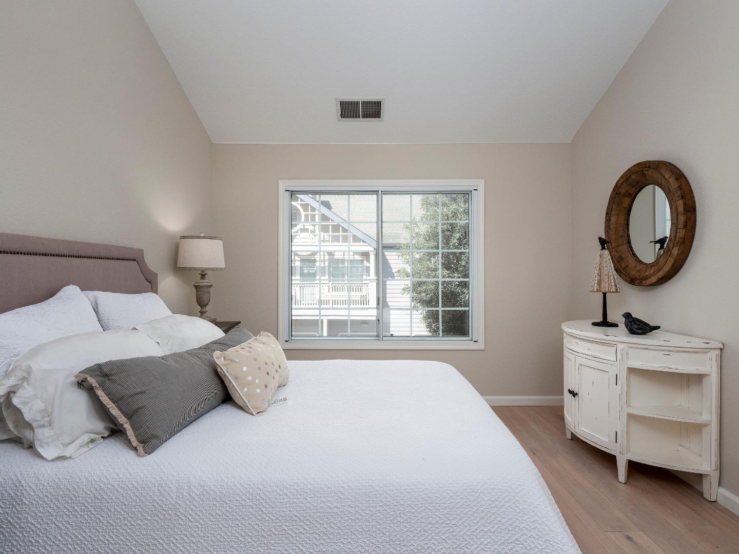 935 Old County Road, Unit 45 Belmont, CA 94002 - Photo 9 of 18 a bedroom with a bed and a large window