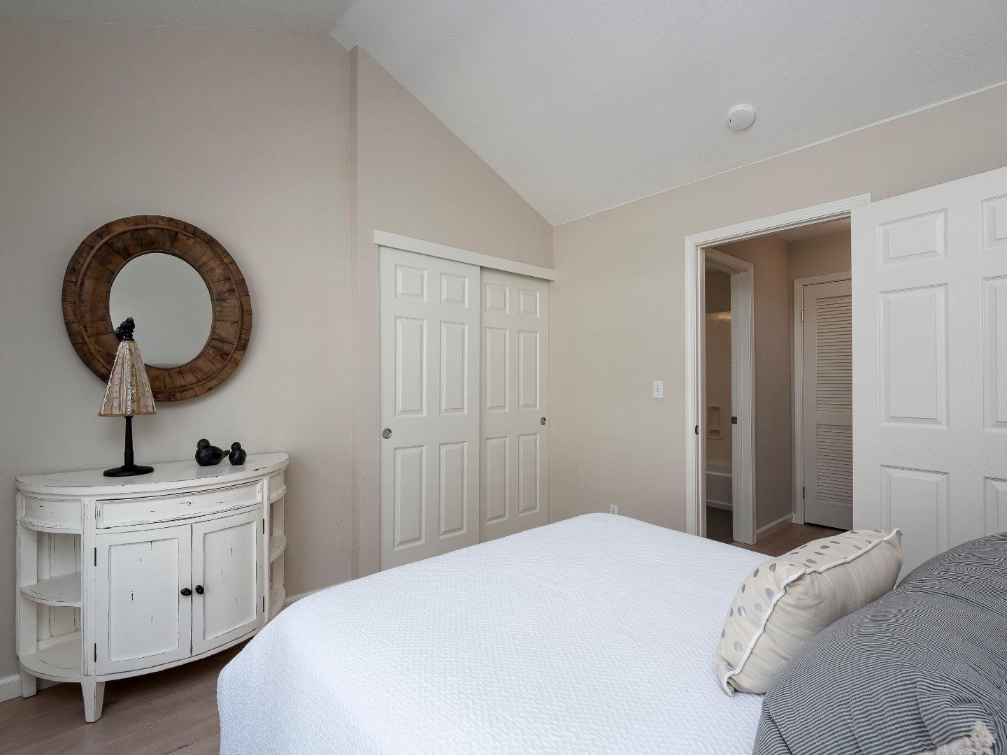 935 Old County Road, Unit 45 Belmont, CA 94002 - Photo 10 of 18 a bedroom with a bed and a large mirror