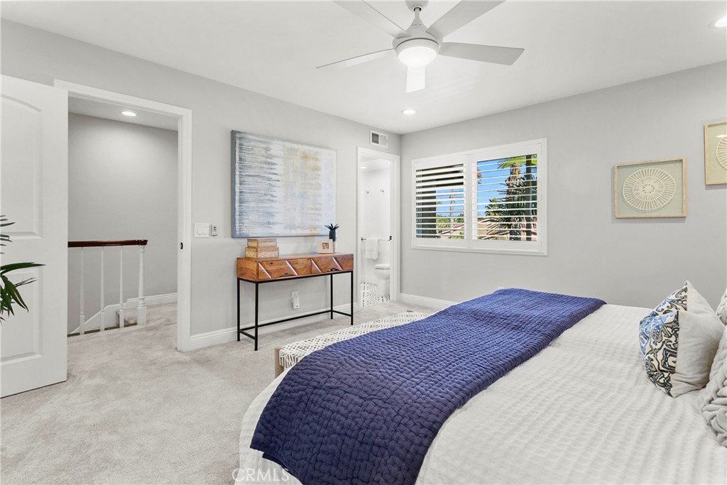 21066 Poolside Lane Huntington Beach, CA 92648 - Photo 11 of 31 a bedroom with a bed and a chandelier