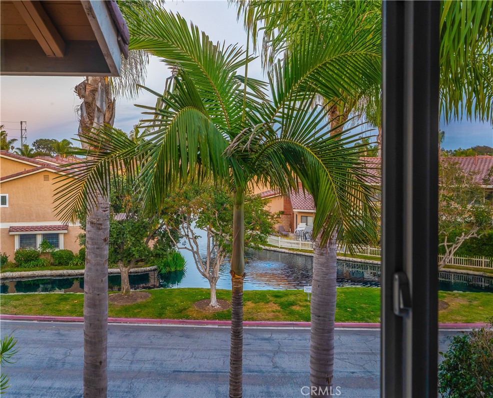 21066 Poolside Lane Huntington Beach, CA 92648 - Photo 13 of 31 a view of a palm trees front of house with wooden fence