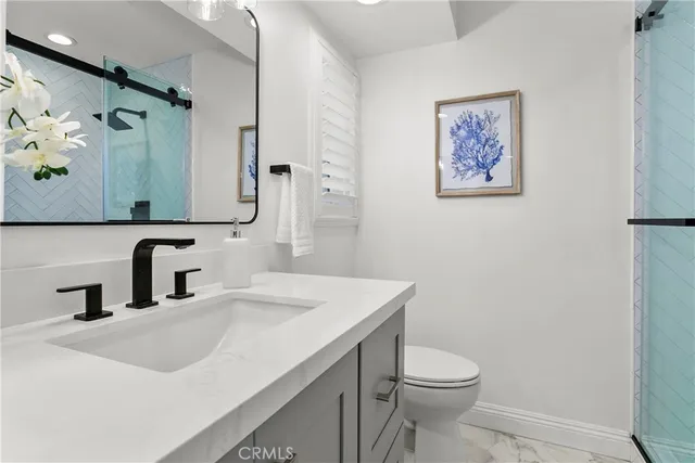a bathroom with a sink mirror vanity and toilet