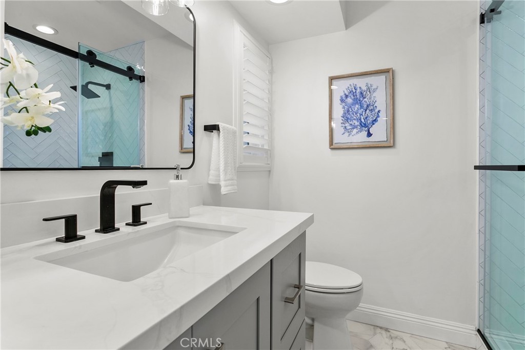 21066 Poolside Lane Huntington Beach, CA 92648 - Photo 17 of 31 a bathroom with a sink mirror vanity and toilet