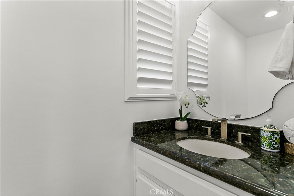21066 Poolside Lane Huntington Beach, CA 92648 - Photo 20 of 31 a bathroom with a granite countertop sink and a mirror