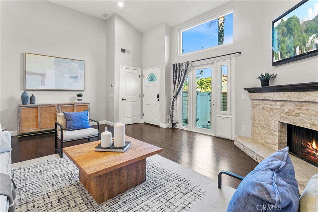 21066 Poolside Lane Huntington Beach, CA 92648 - Photo 2 of 31 a living room with furniture and a fireplace