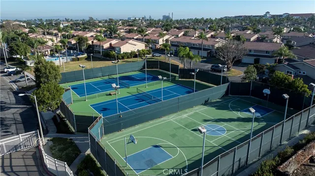 a view of a tennis ground with furniture