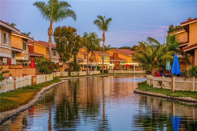 a view of residential houses with outdoor space and swimming pool