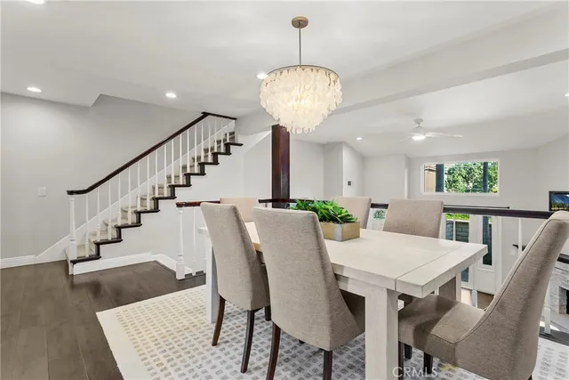 a view of a dining room with furniture wooden floor and chandelier