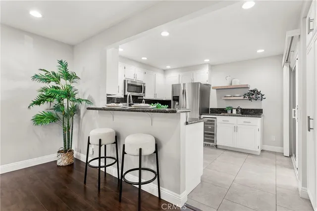 a kitchen with white cabinets and white appliances