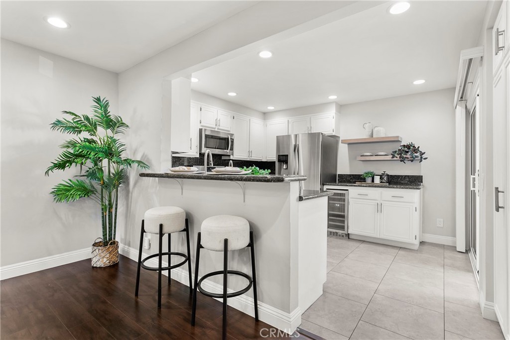 21066 Poolside Lane Huntington Beach, CA 92648 - Photo 6 of 31 a kitchen with white cabinets and white appliances