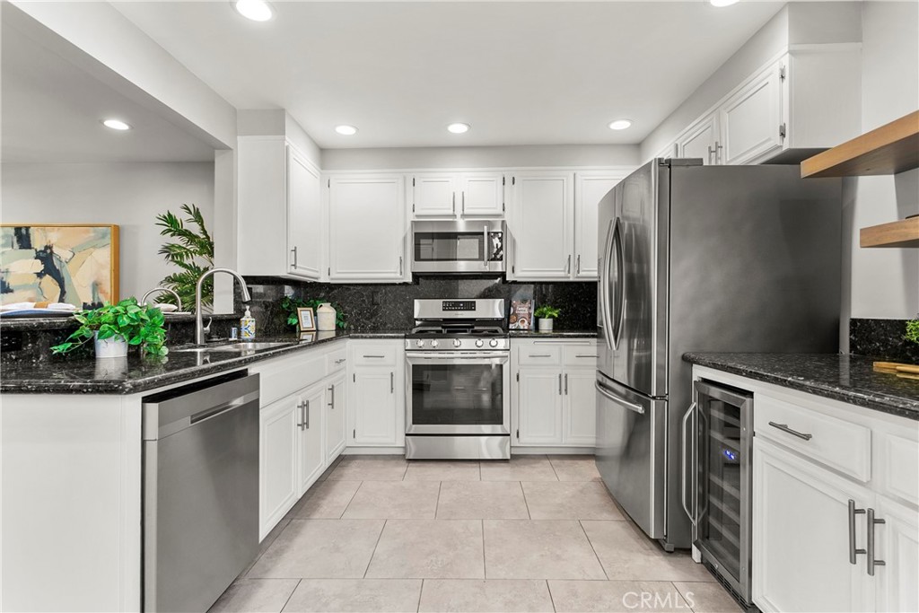 21066 Poolside Lane Huntington Beach, CA 92648 - Photo 7 of 31 a kitchen with a refrigerator sink and microwave