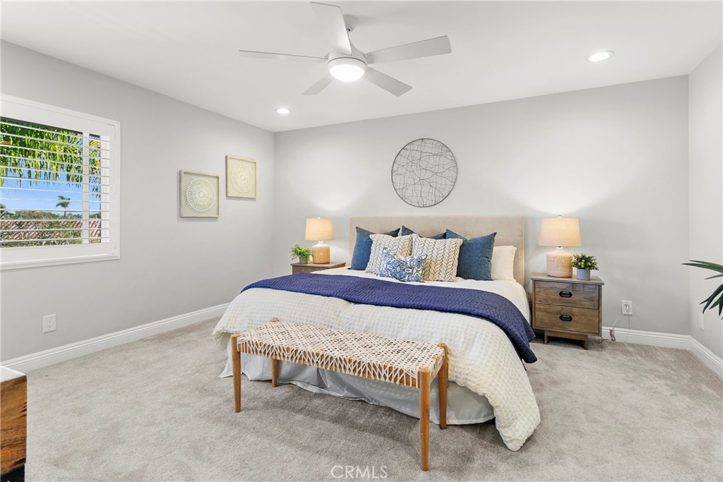 21066 Poolside Lane Huntington Beach, CA 92648 - Photo 10 of 31 a bedroom with a bed and a chandelier