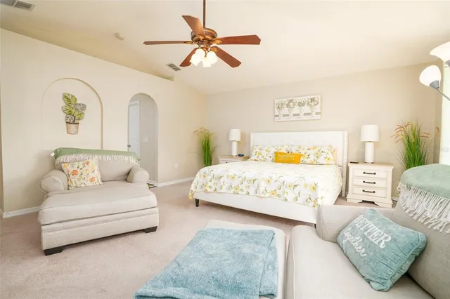 a bedroom with a bed couch and window