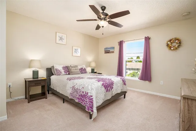 a bedroom with a bed chandelier and a window