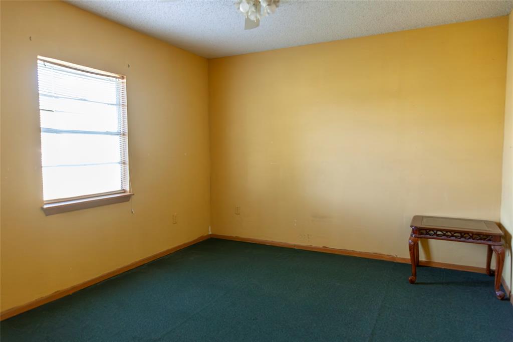 112 Southeast Front Street, Unit A Bailey, TX 75452 - Photo 11 of 39 Empty room featuring a textured ceiling, carpet, and ceiling fan