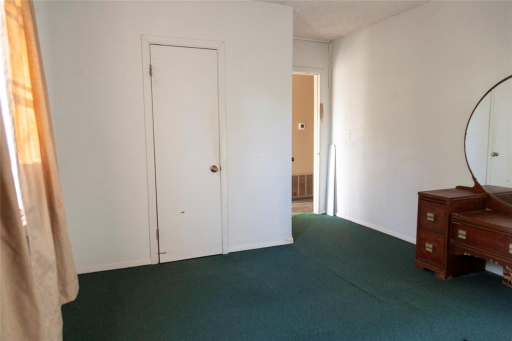 112 Southeast Front Street, Unit A Bailey, TX 75452 - Photo 12 of 39 Bedroom with dark carpet and baseboards