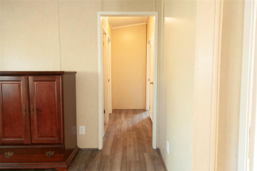 112 Southeast Front Street, Unit A Bailey, TX 75452 - Photo 18 of 39 Corridor featuring wood finished floors and ornamental molding