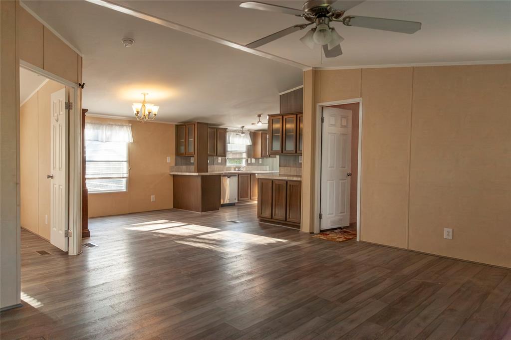 112 Southeast Front Street, Unit A Bailey, TX 75452 - Photo 20 of 39 Kitchen with glass fronted cabinets, light countertops, wood finish cabinetry, ceiling fan, and suspended lighting