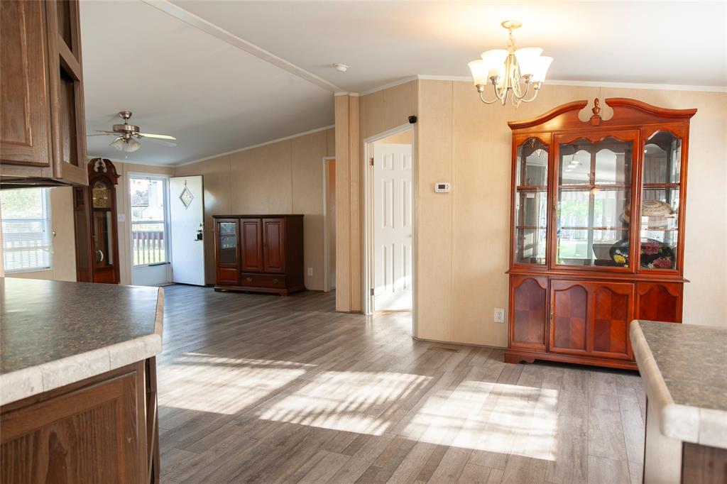 112 Southeast Front Street, Unit A Bailey, TX 75452 - Photo 21 of 39 Unfurnished dining area with ornamental molding, lofted ceiling, ceiling fan, light wood finished floors, and suspended lighting