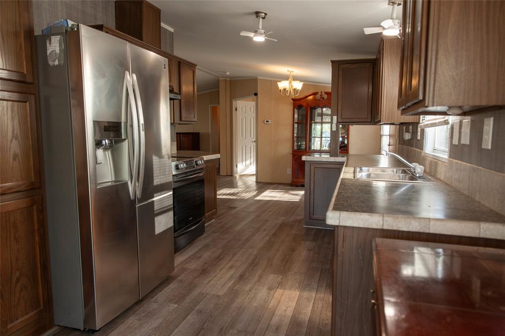 112 Southeast Front Street, Unit A Bailey, TX 75452 - Photo 24 of 39 Kitchen with stainless steel fridge with ice dispenser, range with electric stovetop, hanging lights, dark wood-style floors, and a ceiling fan