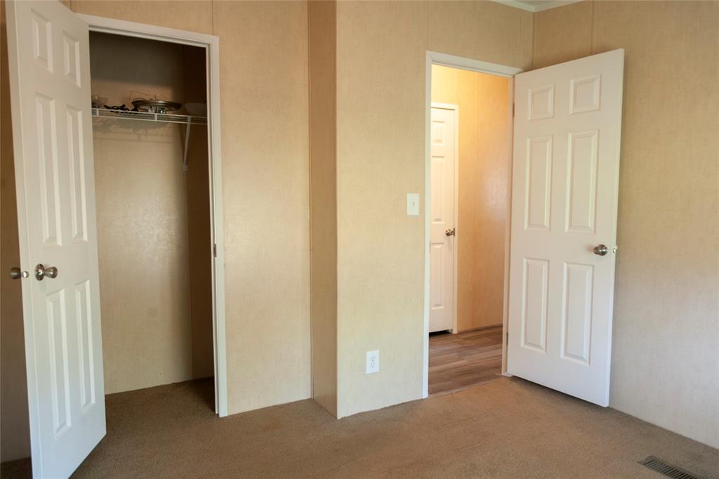 112 Southeast Front Street, Unit A Bailey, TX 75452 - Photo 30 of 39 Unfurnished bedroom with a closet and carpet floors