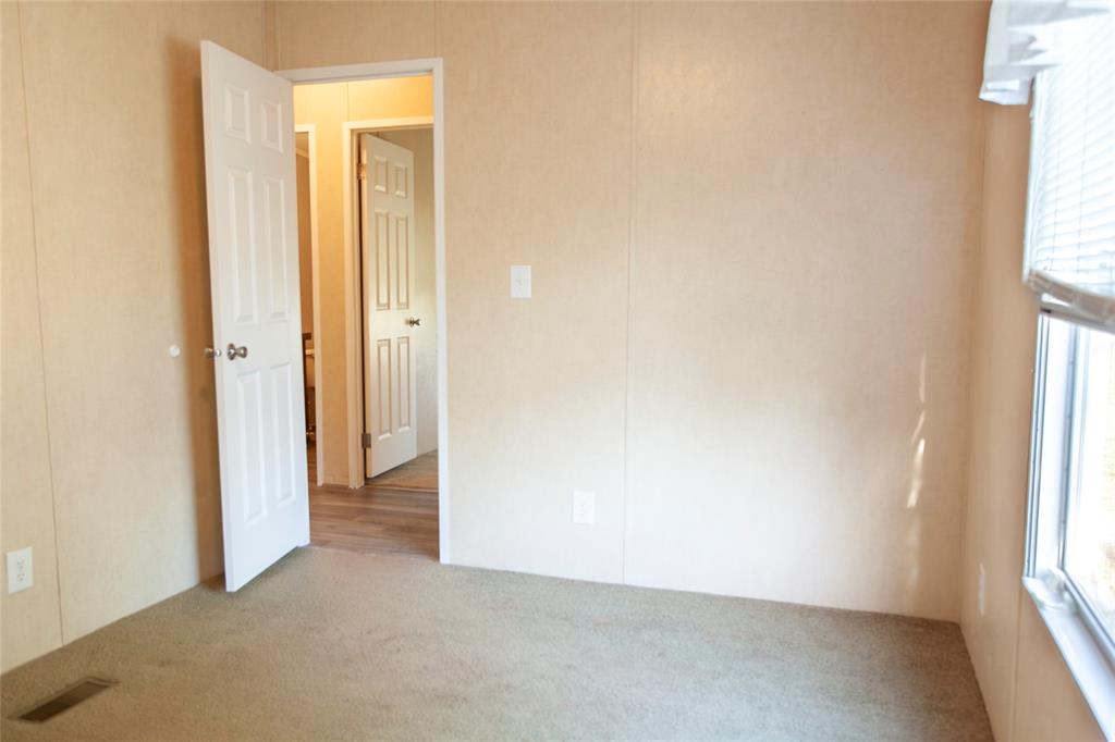 112 Southeast Front Street, Unit A Bailey, TX 75452 - Photo 31 of 39 Spare room featuring plenty of natural light and light carpet