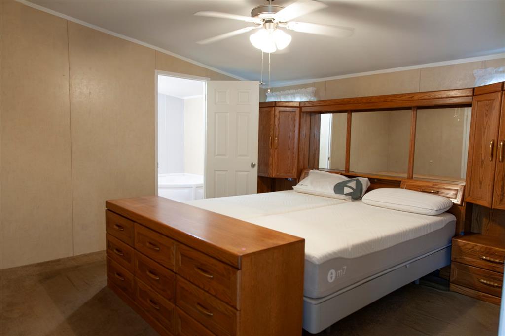 112 Southeast Front Street, Unit A Bailey, TX 75452 - Photo 32 of 39 Bedroom with ornamental molding, ceiling fan, a decorative wall, and vaulted ceiling