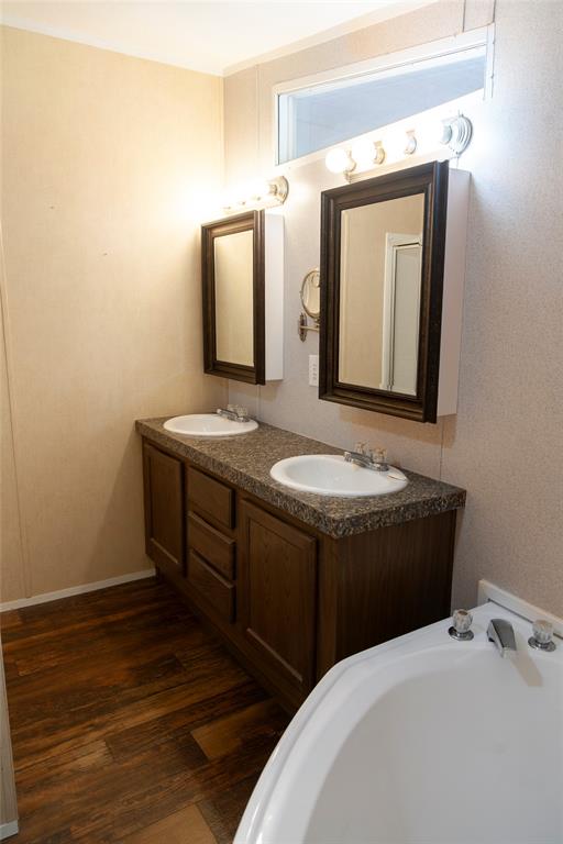 112 Southeast Front Street, Unit A Bailey, TX 75452 - Photo 35 of 39 Bathroom with double vanity, dark wood-style floors, and a bath