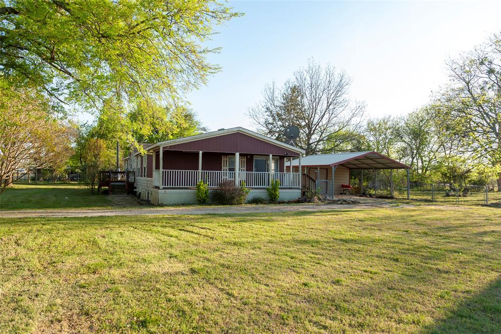 112 Southeast Front Street, Unit A Bailey, TX 75452 - Photo 39 of 39 View of front of house featuring a porch, a front yard, and a carport