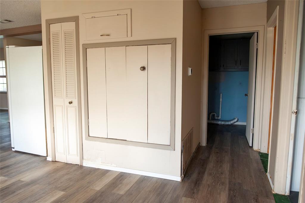 112 Southeast Front Street, Unit A Bailey, TX 75452 - Photo 8 of 39 Hall featuring dark wood-style flooring and a textured ceiling