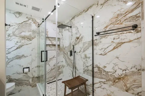 a bathroom with a shower toilet and sink