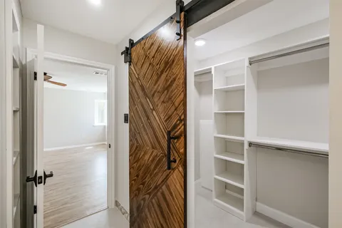 a view of walk in closet with empty racks